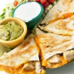Grilled chicken quesadilla with guacamole and sour cream_