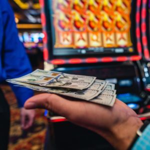 hand full of money won at Triple Crown Casinos
