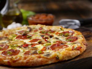 Get Delicious Food at Triple Crown Casinos Deluxe Pizza with Pepperoni, Sausage, Mushrooms and Peppers