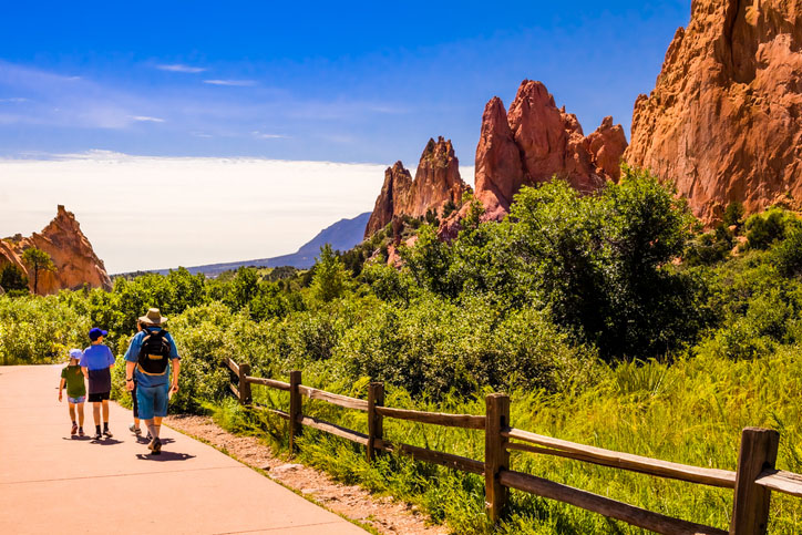 Family walking through Garden of the Gods in Colorado Springs, Colorado, which is a fun summer thing to do.