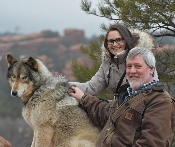 Couple posed with a Wolf