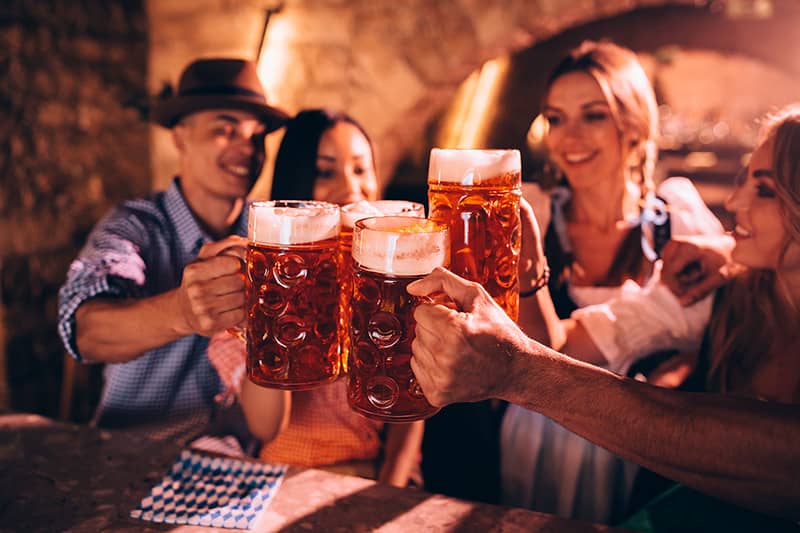 A group of friends toasting Oktoberfest at Triple Crown Casinos