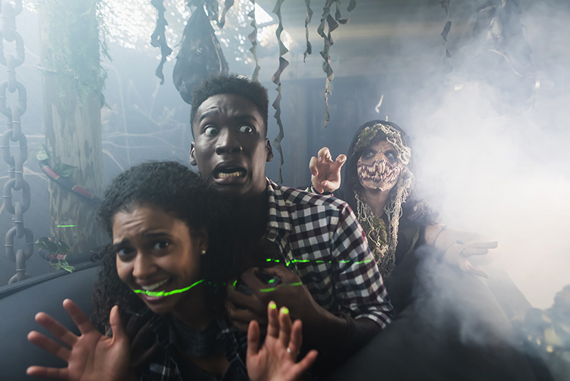 Couple looking scared on a ride during Fright Fest at Elitch Gardens