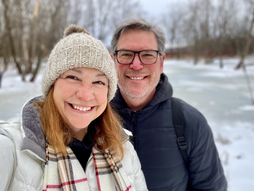 Smiling middle age couple outdoors in winter taking a selfie