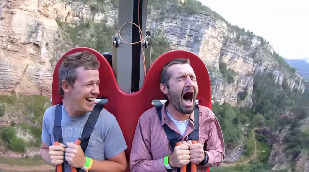 2 men on the Terror-dactyl ride, one laughing, one crying