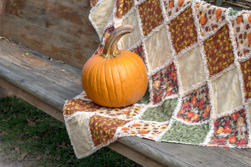 orange pumpkin on a handmade fall quilt