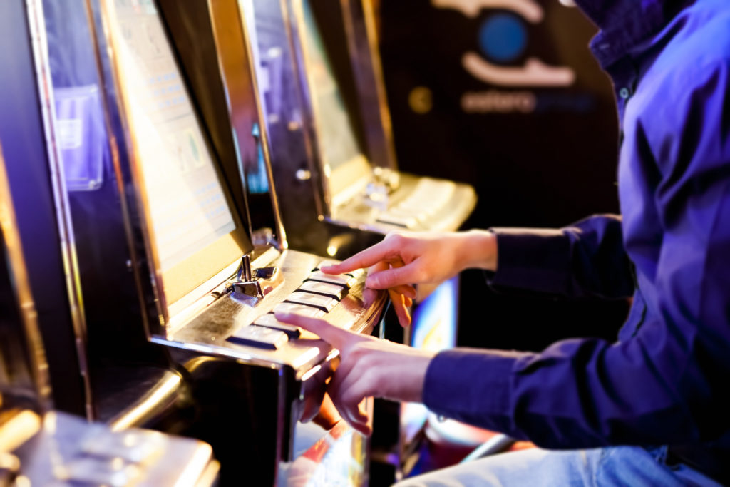 Man having playing an electronic slot machine