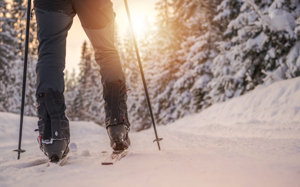 Cross Country Skiing Winter Sport Concept. Ski and Legs Closeup.