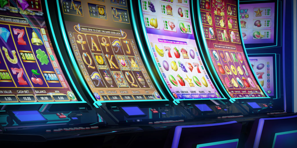 Row of video slot machines with curved display and neon lights