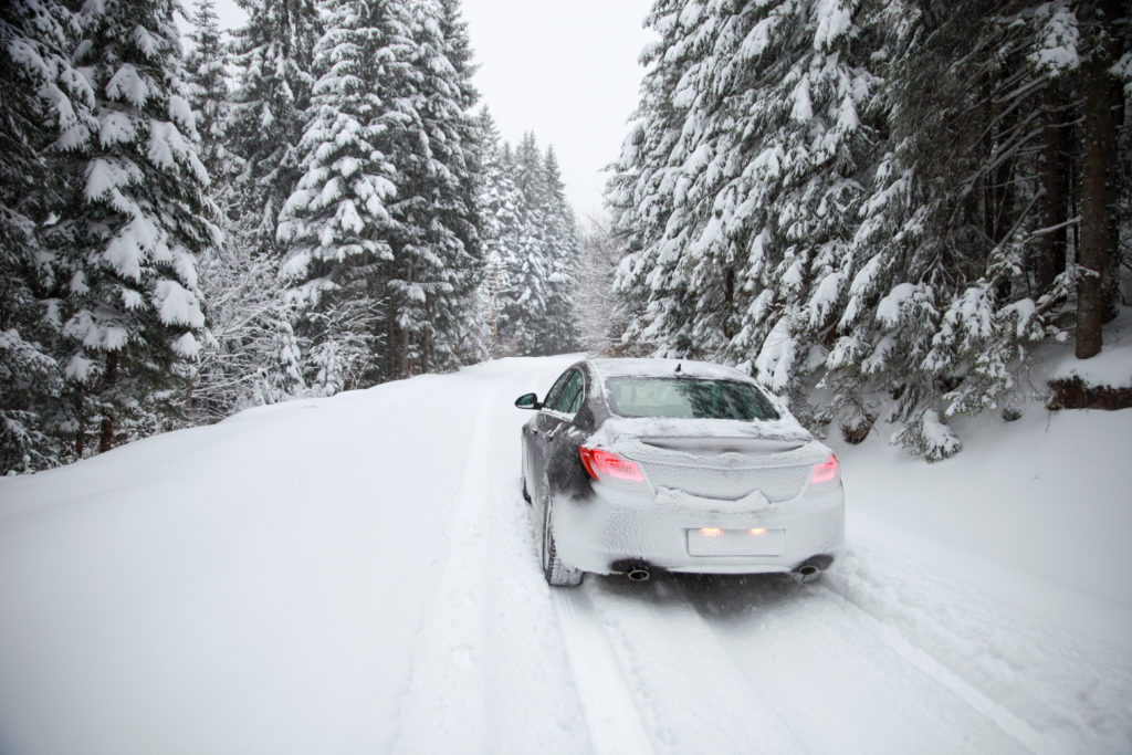 Driving a car on winter rural slippery roads.-Image