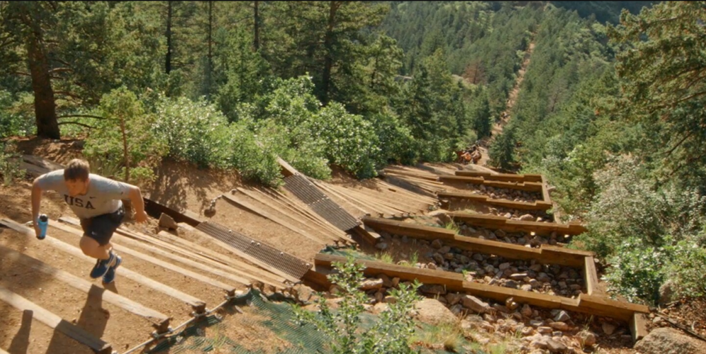 A man running up the Manitou Incline on a sunny day