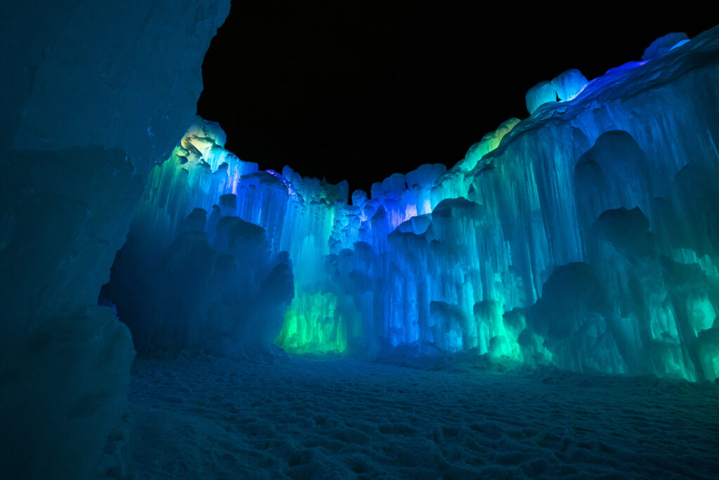 A View of the Ice Castles lit up at night.