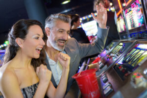 Couple celebrating win on a slot machine