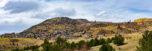A view of Cripple Creek, Colorado, nestled against rolling hills and old mining structures.